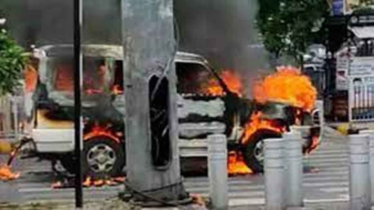 Police escort vehicle catches fire