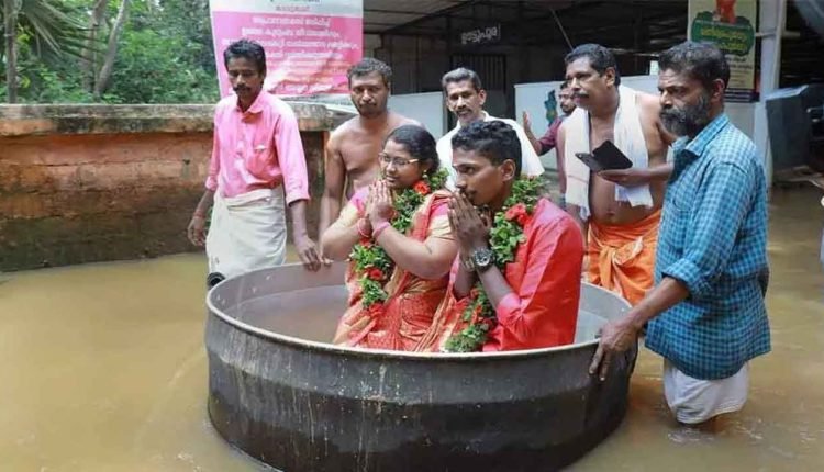 Kerala Couple Reaches Flooded Hall in Cooking Vessel