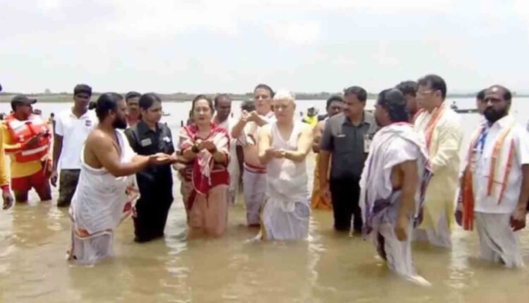 Governor Couple Takes Holy Bath During Saraswati